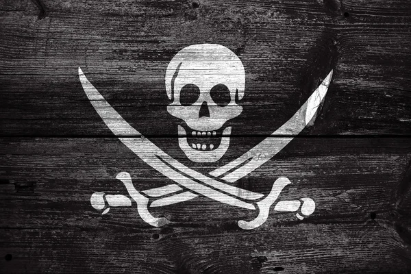 Bandera pirata Calico Jack, pintada sobre fondo de madera vieja —  Fotos de Stock