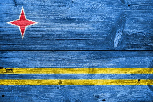 Aruba, målade på gammal trä planka bakgrund flagga — Stockfoto
