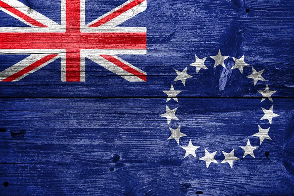 Vlajka Cookových ostrovů, na staré dřevěné prkenné pozadí — Stock fotografie
