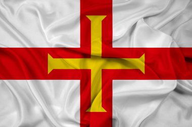 Guernsey bayrağı sallayarak