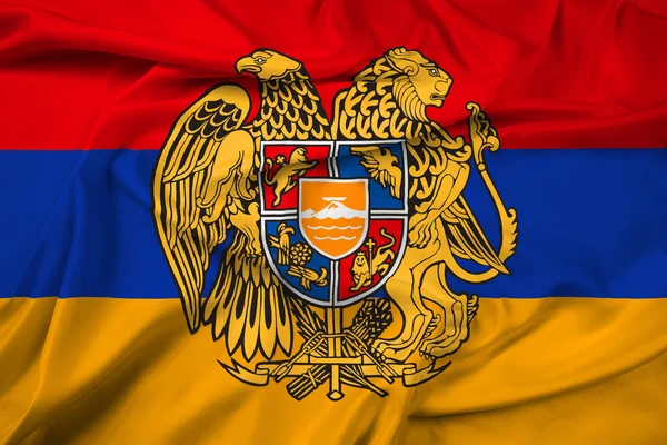 Mávání vlajkou Arménie s erbem — Stock fotografie