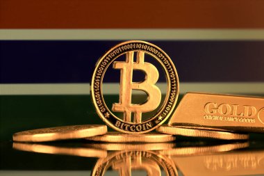 Bitcoin 'in fiziksel versiyonu, altın külçesi ve Gambiya Bayrağı.