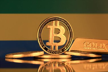 Bitcoin 'in fiziksel versiyonu, altın külçesi ve Gabon Bayrağı.