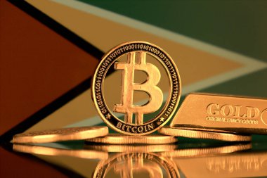 Bitcoin 'in fiziksel versiyonu, altın külçesi ve Guyana Bayrağı.