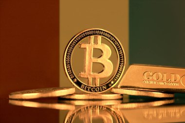 Bitcoin 'in fiziksel versiyonu, altın külçesi ve Gine Bayrağı.