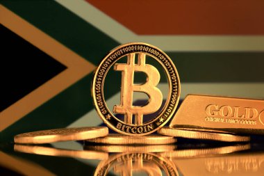 Bitcoin 'in fiziksel versiyonu, altın külçesi ve Güney Afrika Bayrağı.