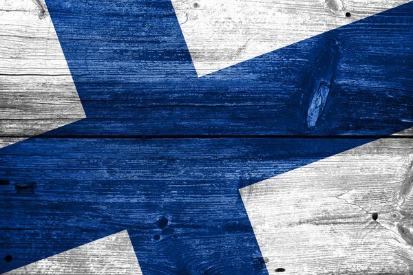 Finsko vlajka na staré dřevěné prkenné pozadí — Stock fotografie