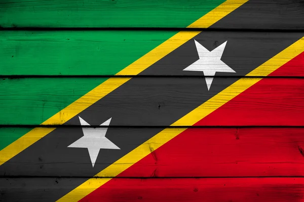 Saint kitts en nevis vlag op hout achtergrond — Stockfoto