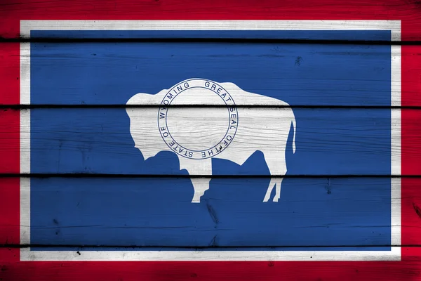 Wyoming State Flag on wood background — Stock Photo, Image