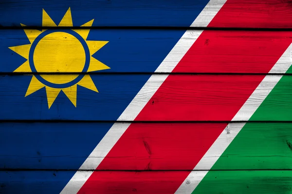 Namibya bayrak ahşap arka plan üzerinde — Stok fotoğraf