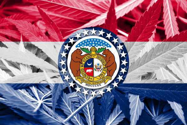 Missouri State Flag on cannabis background. Drug policy. Legalization of marijuana