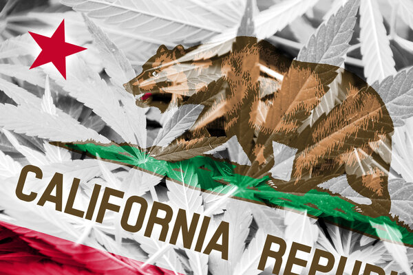 California State Flag on cannabis background. Drug policy. Legalization of marijuana