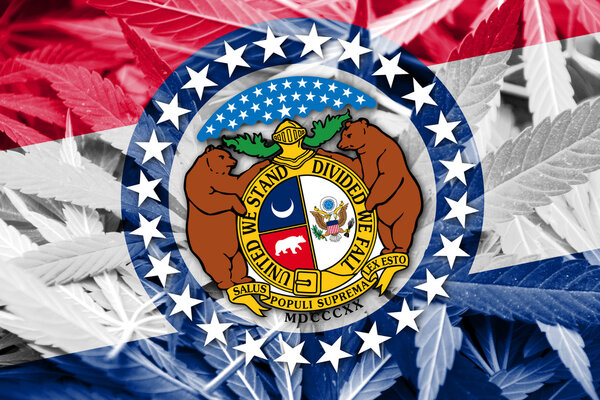Missouri State Flag on cannabis background. Drug policy. Legalization of marijuana