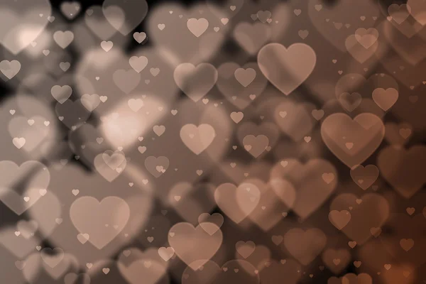 Brown hearts background with bokeh effect — Stock Photo, Image