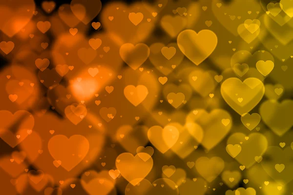 Orange and yellow hearts background with bokeh effect — Stock Photo, Image