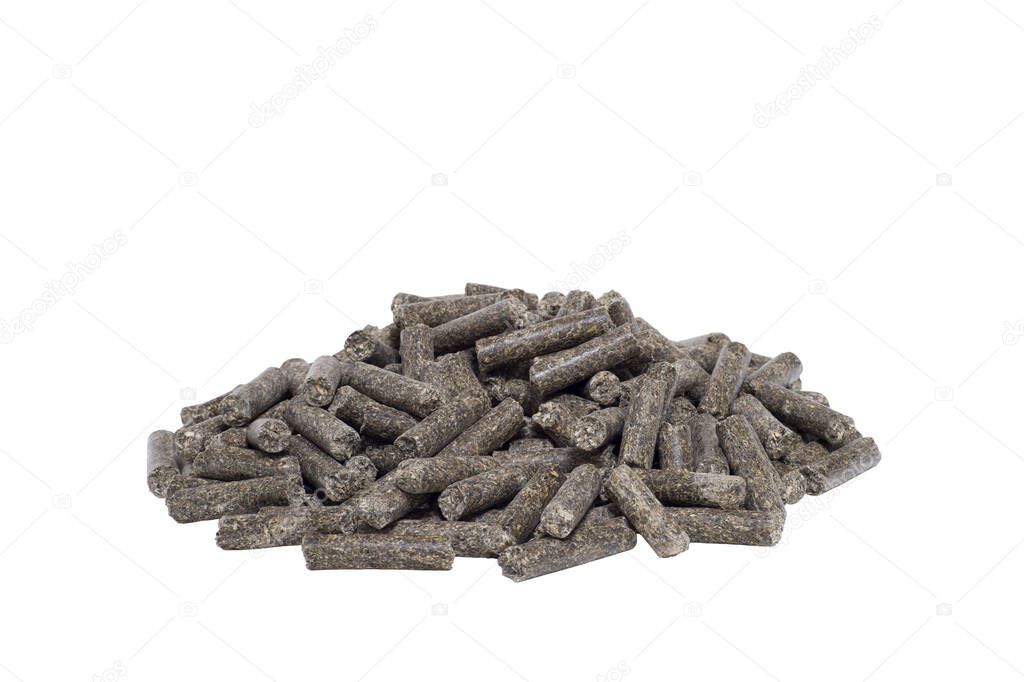 A pile of dark animal feed pellets isolated on a white background