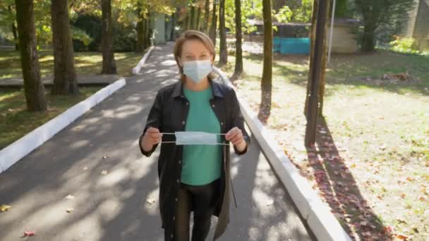 First-person view. a woman in a mask gives a medical mask to a man — Stock Video