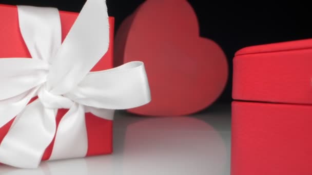 Extremely close-up, detailed. red jewelry gift boxes with white ribbon — Stock Video