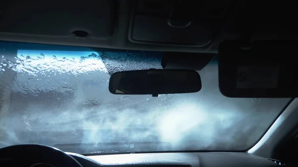 Close-up. espuma branca no vidro do carro. lavagem de carros. espaço de cópia Imagens Royalty-Free