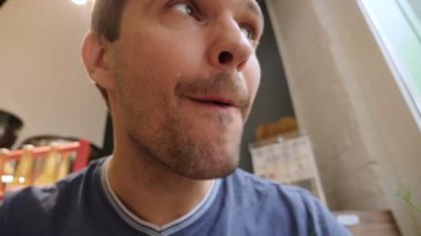 Kafede vejetaryen shawarma yiyen bir adamın yüzünü yakından çek.