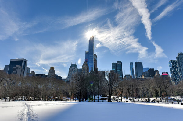 Skyscrapers along Central Park South in New York City, during a snowy winter.