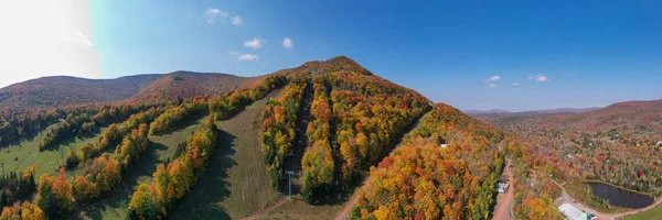 Colorful Hunter Ski Mountain in upstate New York during peak fall foliage.
