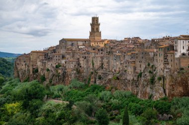 Pitigliano 'nun gökyüzü, dik kayalıklara kurulmuş eski Etrüsk kökleri ve tuff taşı mimarisi ile kaplı..