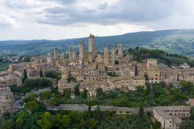 San Gimignanos ortaçağ taş kuleleri ve duvarlarının havadan görünüşü, UNESCO tarafından listelenmiş bir Toskana tepe kasabası bir zamanlar Francigena ticaret merkezi olarak gelişiyordu..