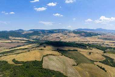 İtalya 'nın Pienza kenti yakınlarındaki Tuscan Tepeleri' nde altın buğday tarlaları ve yoğun yeşil ormanlar vardır..
