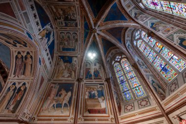 Assisi, İtalya - 17 Temmuz 2025: Karmaşık freskler ve boyalı camlar, İtalya 'nın Assisi kentindeki Papalık Bazilikasının tavanını aydınlatarak 13. yüzyıl İtalyan Gotik sanatına örnek teşkil ediyor.