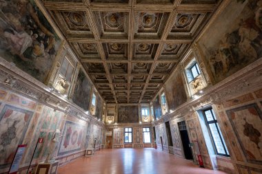 Ducale Palace, Mantua - 25 Temmuz 2025: Mantuas Ducal Palace 'da Rönesans Salonu, içi ahşap tavanlı, mitolojik freskler ve büyük perspektifli iç mekan.