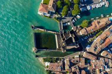 Aerial view of Castello Scaligero di Sirmione, a 13thcentury Scaliger fortress enclosing a fortified harbor on Lake Garda.