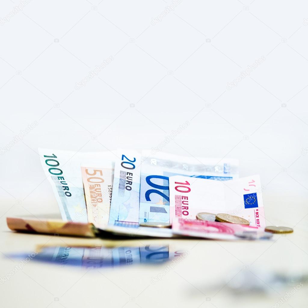 Money euro coins and banknotes on white background in square