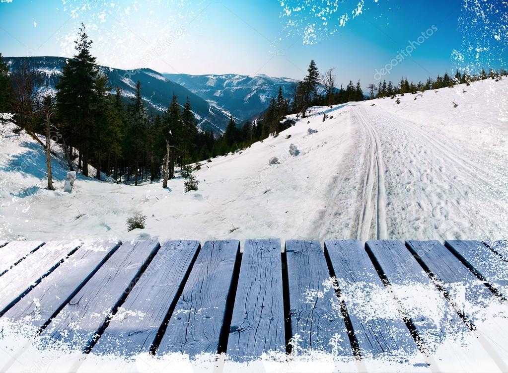 Wooden balcony on winter landscape skiing path with snow grunge