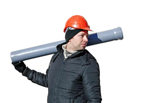 Worker at a construction site in an orange helmet with a sewer pipe — Stock Photo, Image