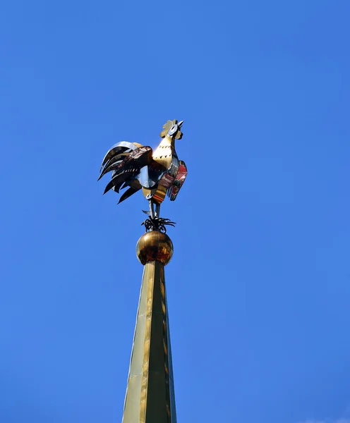 Weathervane in the form of a golden rooster on the spire — Stock Photo, Image