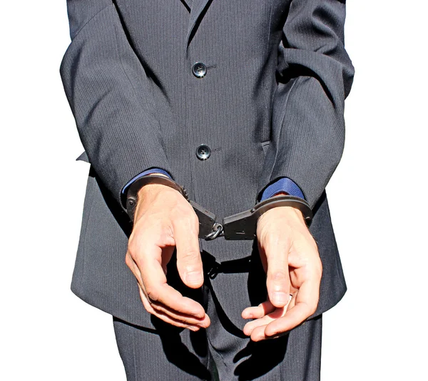 Man in black suit in handcuffs on his hands isolated — Stock Photo, Image