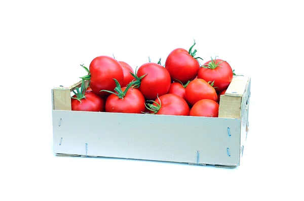 Red tomatoes in a wooden box — Stock Photo, Image