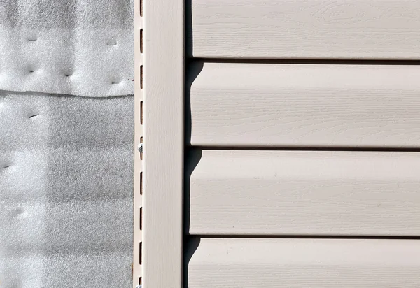 Installation on facade panels beige vinyl siding — Stock Photo, Image