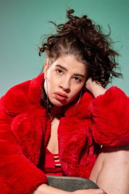 Kırmızı elbiseli beyaz kız portresi koyu gri üzerinde izole edilmiş.