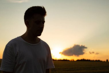 Günbatımının gölgesinde gökyüzü olan beyaz Avrupalı çocuk