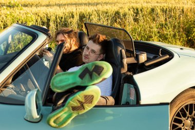 Beyaz modeller, arabada oturan adamlar.