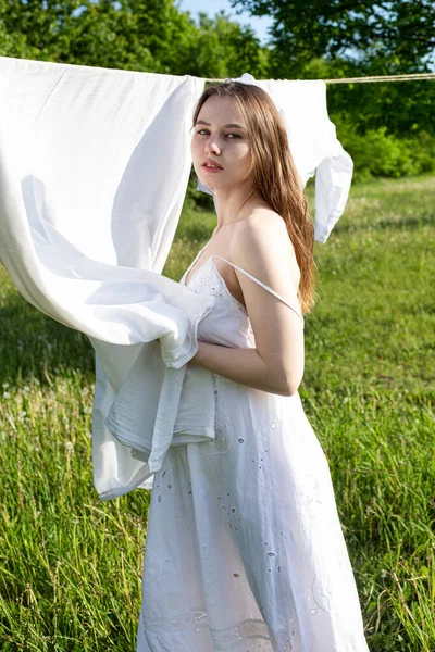 White model girl outside near washed linen