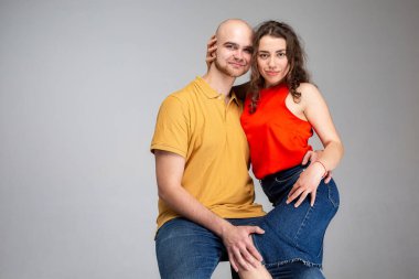 Gri üzerinde yalnız oturan beyaz Avrupalı genç insanlar