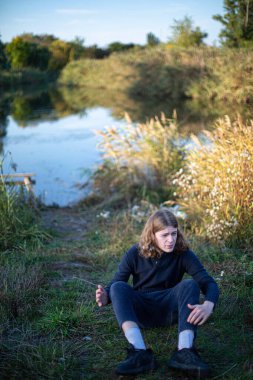 Genç Avrupalı, uzun saçlı, göllü beyaz adam.