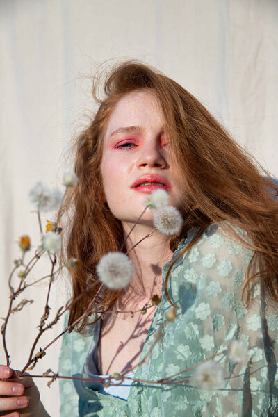 Young european white girl with dark hair portrait with flowers