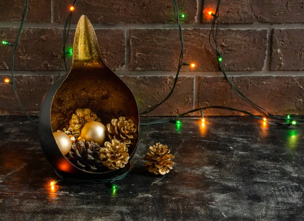 Weihnachten fabelhafte Komposition mit einem ungewöhnlichen Kerzenständer, goldenen Zapfen und Neujahrslichtern - geheimnisvoll, Kopierraum — Stockfoto
