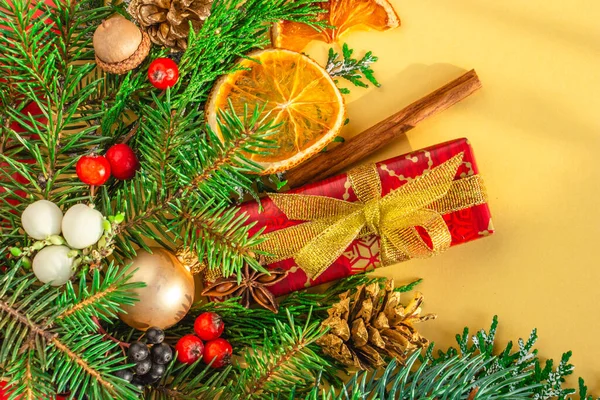 La Navidad y Año Nuevo la postal, el fondo - el abeto, el regalo sobre el fondo dorado. Colocación plana, espacio para copiar, vista superior —  Fotos de Stock
