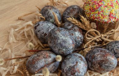 Güzel Paskalya kompozisyonu - renkli yumurtalar, Paskalya pastası, buğday kulakları, geleneksel olarak zarif..