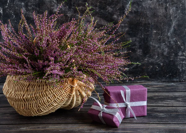 Hasır sepetin içindeki Heather 'ın sonbahar kompozisyonu ve hediyeler, durgun hayat.